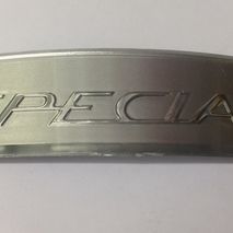 Lambretta silver "Special" shaped rear frame badge 